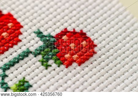 Red Ripe Strawberries Embroidered With A Cross-stich On A White Canvas By Hand. Close Up, Macro. Hob