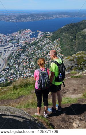 Bergen, Norway - July 23, 2020: People Hike Ulriken Mountain Trail Overlooking City Of Bergen, Norwa