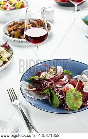 Festive Table With Beef Jerky Appetizer, Brisaola With Lettuce Leaves On The Festive Table With Wine