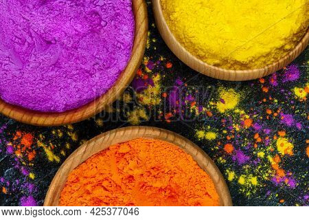 Top View Of Colorful Bright Traditional Holi Pink Yellow Orange Dry Paint Powder In Wooden Bowls Iso