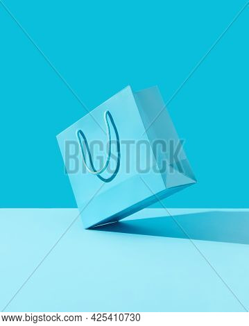 Paper Shopping Bag On Blue Background. Shopping Sale Delivery Concept