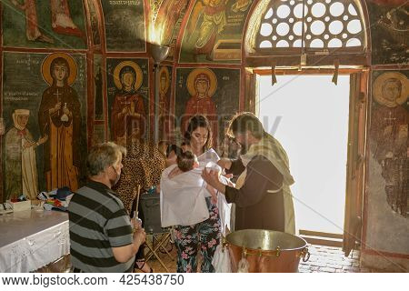 People During A Baptism On The Church Of Panagia Phorviotissa At Nikitari On Cyprus Island
