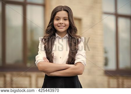 Dedicated To Learning. Confident Lyceum Student Keep Arms Crossed Outdoors. Happy Child Study In Lyc