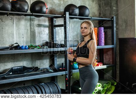 Young Attractive Fitness Woman Posing With Bodybar In The Gym