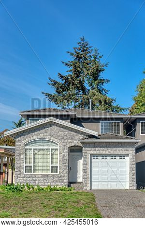 Half Of Residential Duplex House On Bright Sunny Day