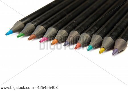 Colored Pencils Lying Diagonally On White Background.