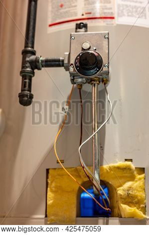 Hot Water Heater Pilot Light And Burner Visible With Base Plate Removed