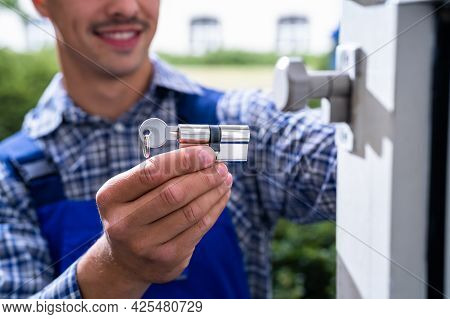 Locksmith Lock Door Repair. Worker Changing And Cylinder