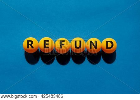 Refund And Bonus Symbol. The Concept Word 'refund' On Orange Table Tennis Balls On A Beautiful Blue 