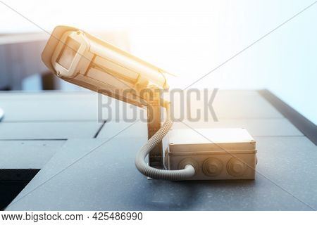 Photo Of A Security Camera Hanging On The Outside Of The Building. Safety And Security Equipment
