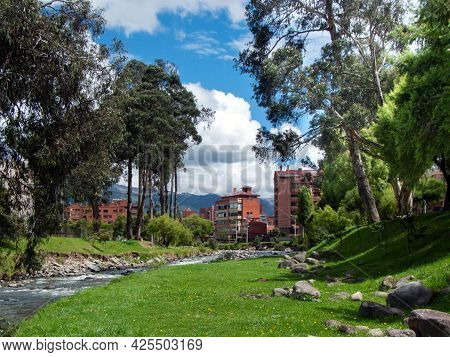 View At The Park Area And Tomebamba River Which Crosses Residential District In Cuenca City, Ecuador