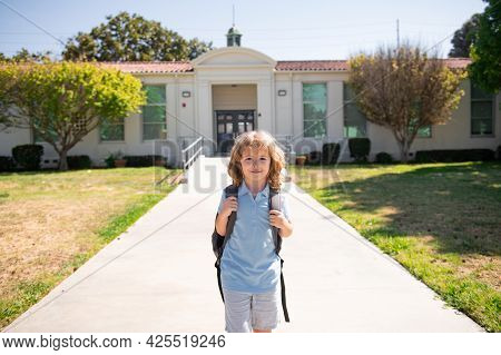 Portrait Of Child Pupul With Rucksacks In The Park Near School. Schoolboy With Backpacks Outdoors. S