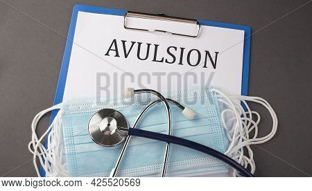 Folder With Paper Text Avulsion , On A Table With A Stethoscope And Medical Masks, Medical