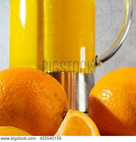 Orange Smoothie In A Blender, Oranges Are Nearby, Close Up. Healthy Lifestyle Concept.