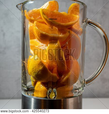Sliced Oranges In A Blender, Close Up. Healthy Lifestyle Concept.