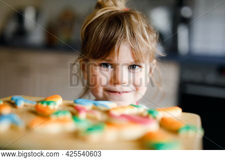 Cute Little Toddler Girl And Fresh Baked Homemade Easter Or Spring Cookies At Home Indoors. Adorable