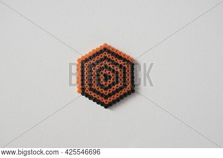 Thermo Mosaic Ready-made Figurines In The Form Orange And Black On White Background