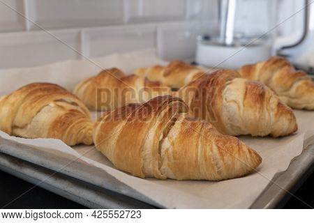 Croissant Baked Fresh On Board With Baking Paper For Homemade Breakfast