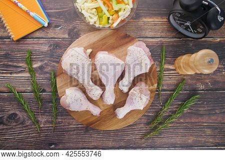 Raw Chicken Drumstick On A Chopping Board