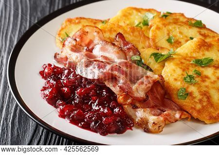 Swedish Potato Pancakes With Fried Pork Raggmunk Med Flask Close-up In A Plate On The Table. Horizon
