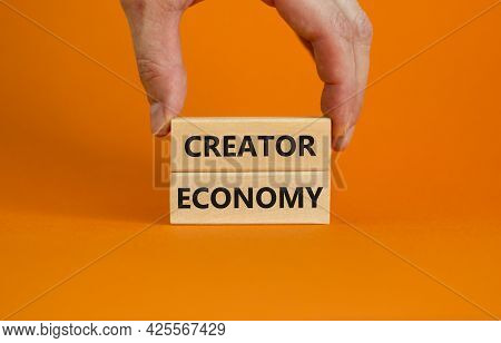 Creator Economy Symbol. Wooden Blocks With Words Creator Economy On Beautiful Orange Background, Cop