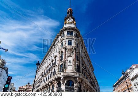 Madrid, Spain - May 8, 2021: The Four Seasons Hotel In Canalejas. Low Angle View Against Bright Blue
