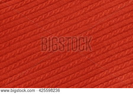 Close Up Background Texture Of Red Cable Knitted Wool Jersey Fabric Sweater With Row Braid Pattern