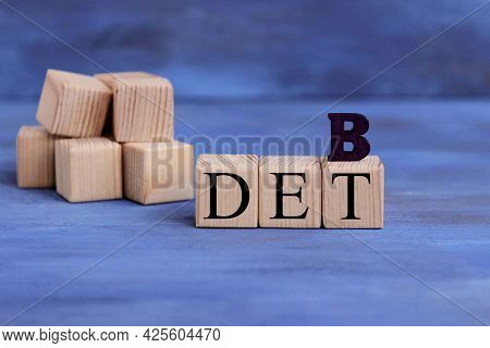 Wooden Blocks With The Word Debt. Reduction Or Restructuring Of Debt. Refusal To Pay Debts Or Loans 