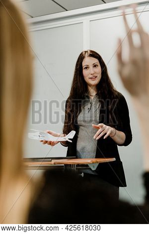 Woman explaining aerodynamics in a classroom