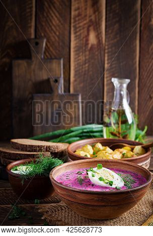 Cold Borscht, Summer Beet Soup With Fresh Cucumber,  Boiled Egg And Baked Potatoes On Wooden Table. 