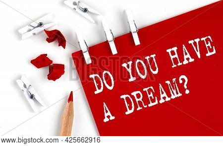 Do You Have A Dream Text On Red Paper With Office Tools On White Background