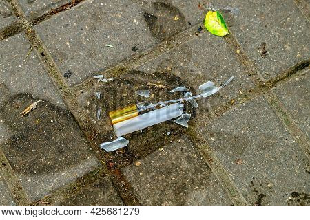 The Elegant Bottle Of Women's Perfume Is Broken On The Paving Tile. The Perfume Is Spilled. Smithere
