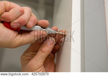 Close Up Of Carpenter Hands Marks The Furniture With A Kerner.