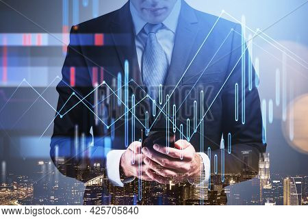 Front View Businessman In Formal Suit Checking Stock Market Rates In Smartphone. Hologram Charts. Bu