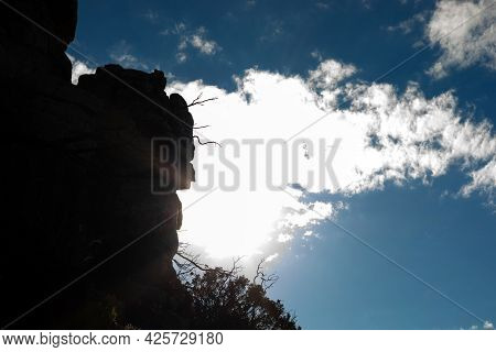 Dramatic View Of Silhouette Mountainside Against Sundog Sky