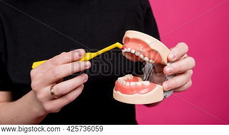 Beautiful Happy Young Woman With Single Tufted Toothbrush On Blank Pink Background