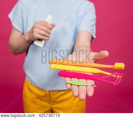 Beautiful Young Woman Uses An Oral Care Kit Consisting Of A Tongue Scraper, Single Tufted And Interd