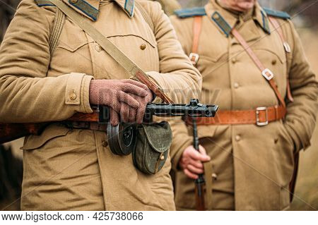 Re-enactor Dressed As Russian Soviet Infantry Soldier Of World War Ii With Sub-machine Gun Weapon. R