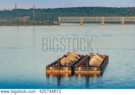 Dry Cargo Barges With Sand For Construction Stand On The Roadstead Against The Background Of Bridges