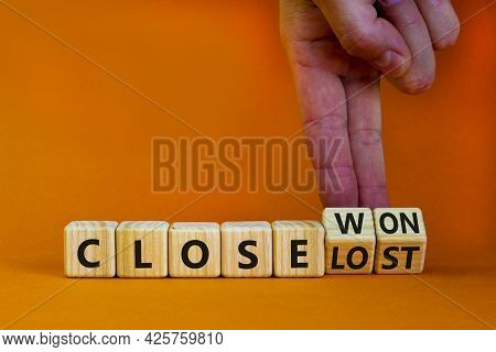 Close Won Or Lost Symbol. Businessman Turns Wooden Cubes And Changes Words Close Won To Close Lost. 