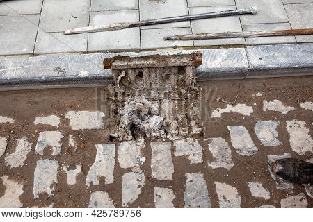 Next To A Footpath There Is A Clogged Gully With Dirt