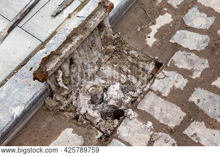Next To A Footpath There Is A Clogged Gully With Dirt