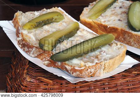 Sandwich with melted lard and pickled cucumbers. Selective focus.
