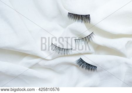 Collection Of Black False Eyelashes On Cotton White Background