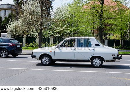 Bucharest, Romania, 24 April 2021 Old Retro White Romanian Dacia 1310 Classic Car In Traffic In A St