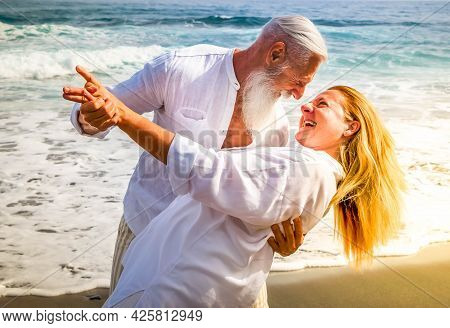Lifestyle With Smiling Caucasian Senior Couple Dance On Beach, Happy In Love Romantic And Relax Time
