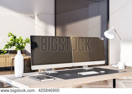 Modern Office Interior With Desktop, Empty Black Computer Monitors And Other Items. Mock Up, 3d Rend