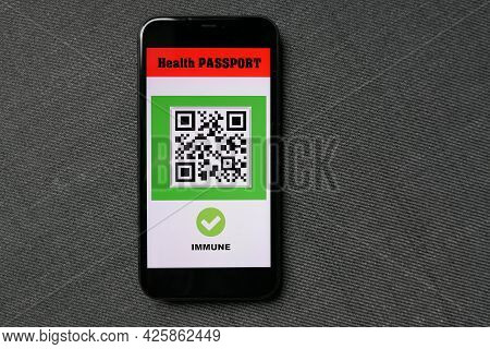 Smartphone On Grey Background With Digital Health Passport App For Travel Covid-19 Immune