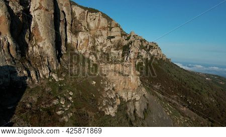 Flying Close To Rocky Mountain Slopes Stones Of Unusual Shapes. Shot. Aerial View Of Amazing Natural