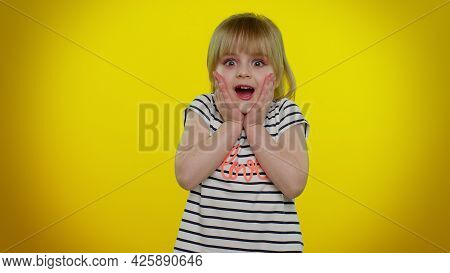 Oh My God, Wow. Excited Amazed Blonde Child Girl 5-6 Years Old Raising Hands In Surprise Looking At 